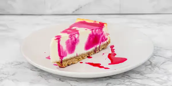 Slice of cheesecake with a berry swirl at Yallah Eat on Pembina Hwy, Winnipeg