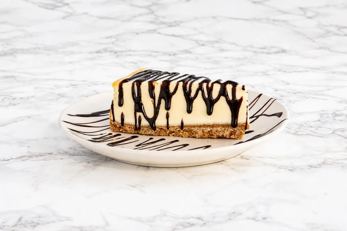 Cheesecake slice with chocolate drizzle at Yallah Eat on Pembina Hwy, Winnipeg