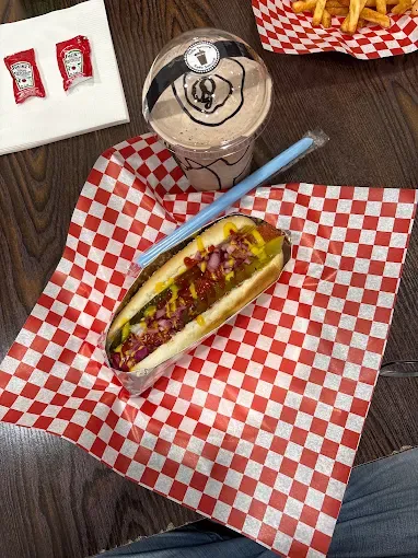 Hot dog and a milkshake on the table at Yallah Eat on Pembina Hwy, Winnipeg