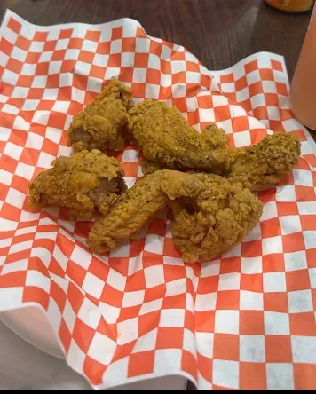 Crispy chicken wings served in a basket at Yallah Eat on Pembina Hwy, Winnipeg