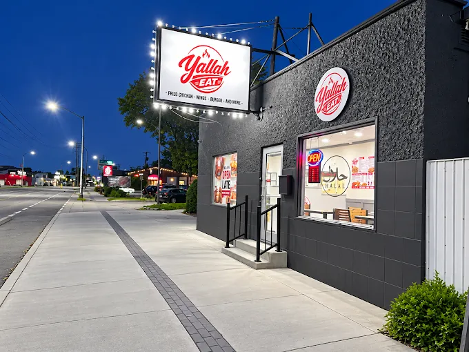 Yallah Eat storefront lit up at night on Pembina Hwy, Winnipeg